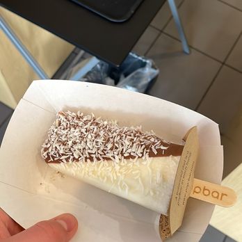 Popbar - New Orleans - Coconut popsicle dipped in milk chocolate - Gelato Near Me - New Orleans, Louisiana Popbar - New Orleans - Coconut popsicle dipped in milk chocolate - Gelato Near Me - New Orleans, Louisiana