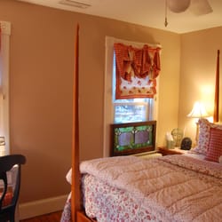 Inn at Horn Point - Antique stained glass dresses a window overlooking the front gardens.