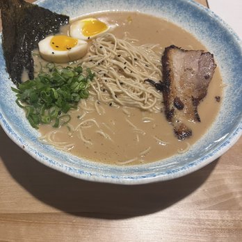 Trio Ramen - Miso base, chatsu (basically pork belly), scallions, with an added onion - A bowl of ramen featuring broth, noodles, sliced pork, soft-boiled eggs, chopped green onions, and a sheet of seaweed. - Ramen Near Me - Middleton, Wisconsin
