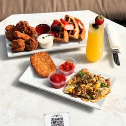 Bello Pizza - Brunch! Chicken wings with berry covered waffles, hash brown, and egg scramble with a loaded berry mimosa.