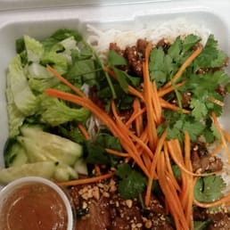a styrofoam container filled with asian food a styrofoam container filled with asian food