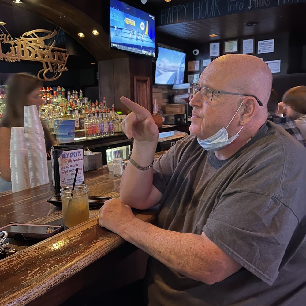 Library Bar - a man wearing a face mask - Beer Bar Near Me - Bourbonnais, Illinois Library Bar - a man wearing a face mask - Beer Bar Near Me - Bourbonnais, Illinois
