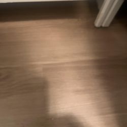 Installer Luis placed luxury vinyl flooring underneath closet with shelving