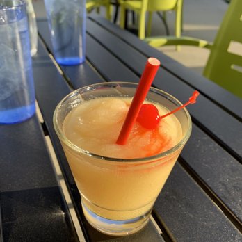 The Standard - a glass of orange juice on a table - Bars Near Me - Covington, Kentucky