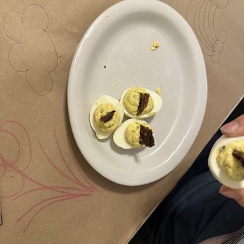 The Kitchen Table - Deviled eggs -- or what's left of them after everyone started grabbing them! Topped with candied bacon! - Southern Near Me - Arlington, Tennessee