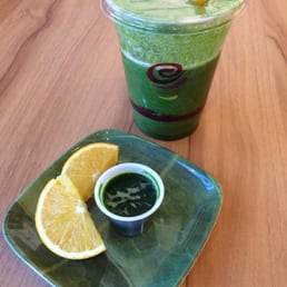 Tropical Greens juice and a single shot wheat grass with orange wedge chaser. Tropical Greens juice and a single shot wheat grass with orange wedge chaser.
