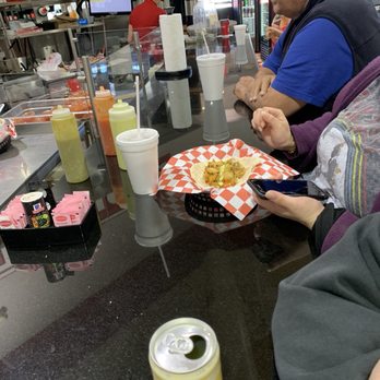 Culebra Meat Market - a man and a woman sitting at a table eating - Grocery Near Me - San Antonio, Texas Culebra Meat Market - a man and a woman sitting at a table eating - Grocery Near Me - San Antonio, Texas