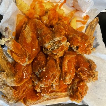 Harolds Shrimp & Chicken - Fried chicken wing and fries with hot sauce on top - Chicken Wings Near Me - Houston, Texas Harolds Shrimp & Chicken - Fried chicken wing and fries with hot sauce on top - Chicken Wings Near Me - Houston, Texas