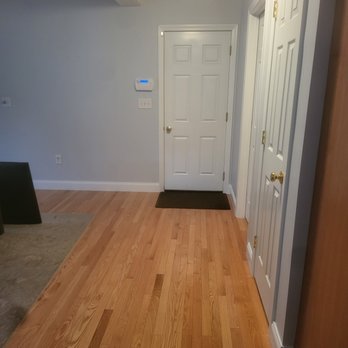 LR Painting & Carpentry - a hallway with hardwood floors - Painters Near Me