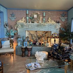 Crystal Blue Lagoon Bed & Breakfast - Sitting room with fireplace deorated with beautiful mermaids and other charming pieces