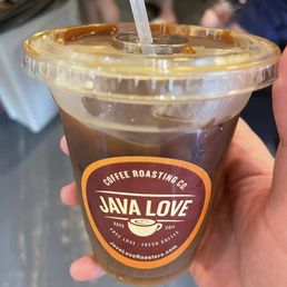 a hand holding a cup of coffee