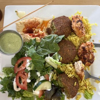 The Green Olive - Combo plate with falafel and chicken, over yellow rice, hummus and salad - Mediterranean Near Me - Des Moines, Iowa The Green Olive - Combo plate with falafel and chicken, over yellow rice, hummus and salad - Mediterranean Near Me - Des Moines, Iowa