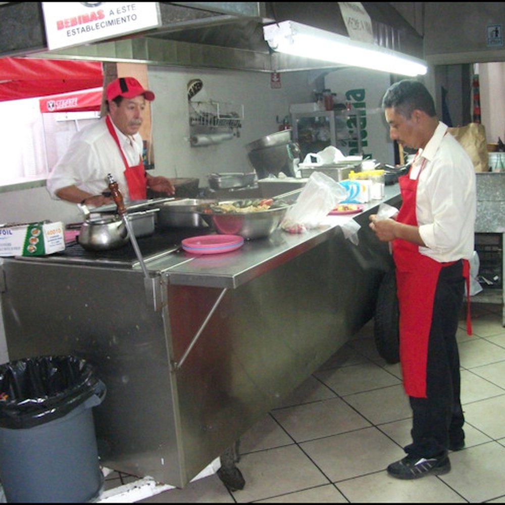 Tacos El Chiapas - The "kitchen," if you want to call it that, is a street vendor cart with a flat tire, that has been moved inside the building.  It all works - Mexican Near Me - Tijuana, BCN