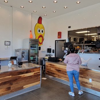 Dave's Hot Chicken - a woman standing at the counter - Chicken Shop Near Me - Plano, Texas