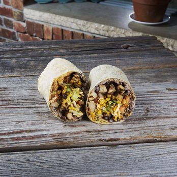 Queso Grill - two burritos on a wooden table - Mexican Near Me - Lincroft, New Jersey Queso Grill - two burritos on a wooden table - Mexican Near Me - Lincroft, New Jersey
