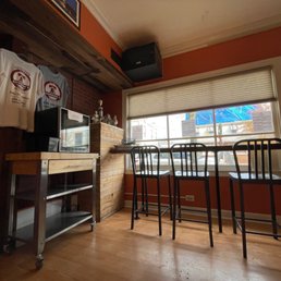 a kitchen with bar stools a kitchen with bar stools