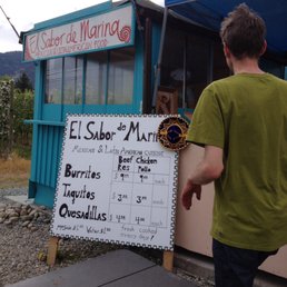 a man standing in front of a restaurant a man standing in front of a restaurant