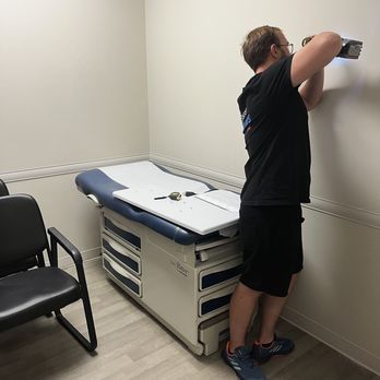 Space Movers - Space Mover drilling the wall in order to install small appliances - Movers Near Me - Calgary, Alberta Space Movers - Space Mover drilling the wall in order to install small appliances - Movers Near Me - Calgary, Alberta