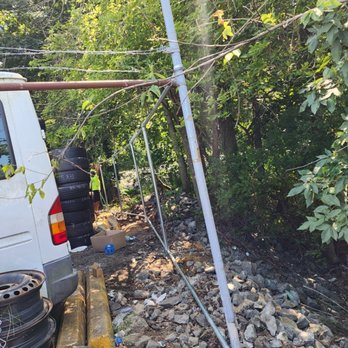 Two Men Fence Installation - a van parked in the yard - Fences & Gates Near Me Two Men Fence Installation - a van parked in the yard - Fences & Gates Near Me