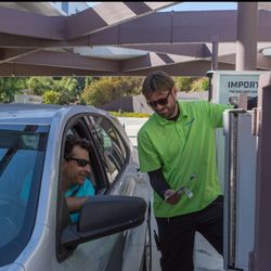 Westlake Village Speedwash - Speedwash employee in green uniform providing excellent service at the fueling station, reinforcing a customer-first experience.