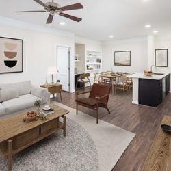 Camden Silo Creek Apartments - Living and dining area with built-in desk and bookshelves at Camden Silo Creek apartments in Ashburn, VA