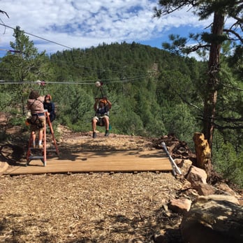 The High Five Eco Zip Tour - Our guide Jesse helping some people off the line. - Tours Near Me - Glorieta, New Mexico The High Five Eco Zip Tour - Our guide Jesse helping some people off the line. - Tours Near Me - Glorieta, New Mexico
