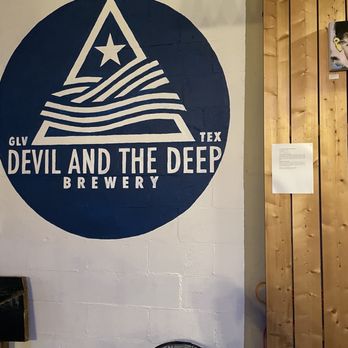 Devil and the Deep Brewing - a blue and white sign - Breweries Near Me - Galveston, Texas