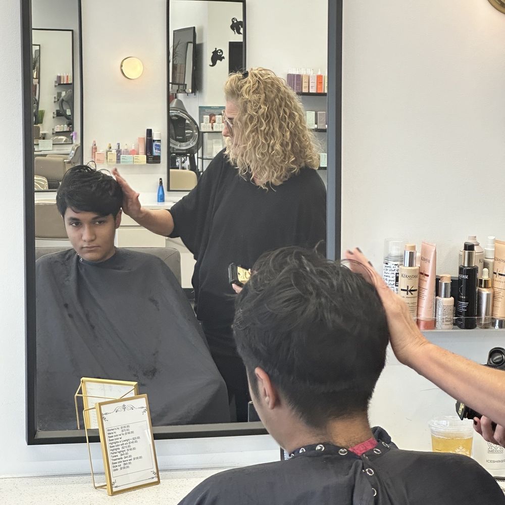 Mere Salon - Demetrios receiving hair cut from Lucinda. - Hair Salons Near Me - Dallas, Texas Mere Salon - Demetrios receiving hair cut from Lucinda. - Hair Salons Near Me - Dallas, Texas