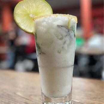 Panela - a shot of a drink with a lime slice on the rim - Colombian Near Me - Lowell, Massachusetts
