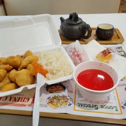 a tray of chinese food and a teapot