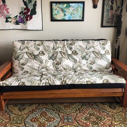 Full size storage arm futon in teak with Hawaiian leaf print cover