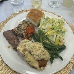 NY strip steak with cowboy butter, Caesar salad, chicken, cheesy scalloped potatoes, and sautéed green beans NY strip steak with cowboy butter, Caesar salad, chicken, cheesy scalloped potatoes, and sautéed green beans