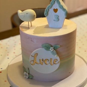 Caramela By Ines - a cake with a bird and birdhouse on top - Custom Cakes Near Me Caramela By Ines - a cake with a bird and birdhouse on top - Custom Cakes Near Me