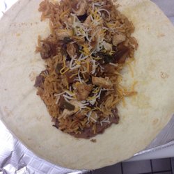 Large chicken fajita taco with refried beans, shredded cheese, homemade rice and homemade chicken with peppers and onion