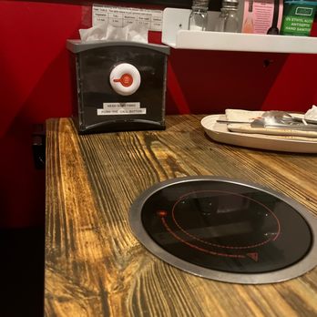 Hot Pot - a wooden counter top with a burner - Chinese Near Me - Wallingford, Connecticut