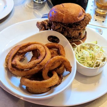 Yard House - Nashville hot chicken sandwich with onion rings. - New American Near Me - Sarasota, Florida