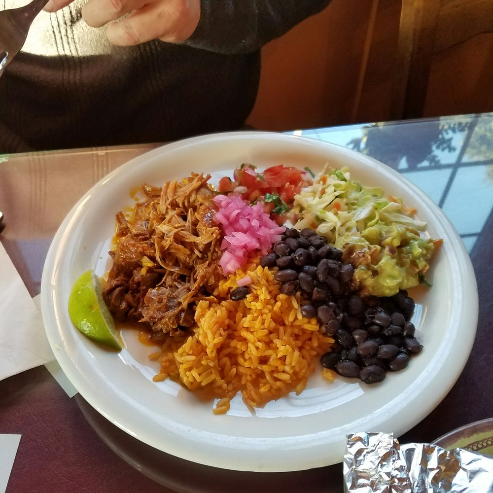 Café Capistrano - Poc chuc shredded tender pork with guacamole, rice,black beans,coleslaw salsa,onion seved with corn tortillas pn side - American Near Me - Half Moon Bay, California