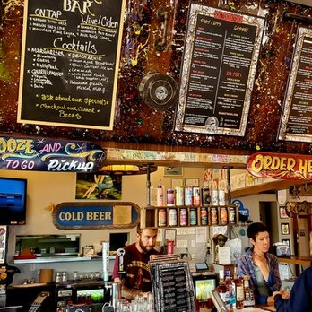 Taco Del Gnar - A bar counter with staff, menu boards, and signage including 'Cold Beer' and 'Order Here' in a casual dining setting. - Tacos Near Me - Ridgway, Colorado