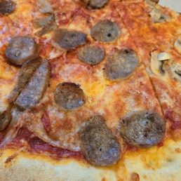 Dried-out sausage on a not-fresh pizza.