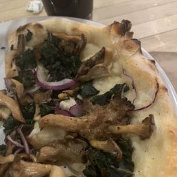 Vegan pizza with mushrooms, chard, and onions.