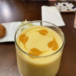 Roys Indian Restaurant - Creamy mango lassi with...mango art