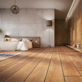 Rogers Floors - a bedroom with a wooden floor - Flooring Near Me