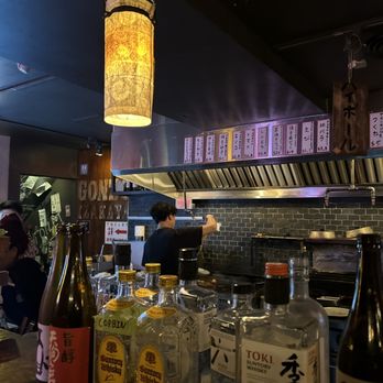 Gonzo Izakaya - a restaurant counter with bottles of alcohol - Japanese Near Me - Toronto, Ontario Gonzo Izakaya - a restaurant counter with bottles of alcohol - Japanese Near Me - Toronto, Ontario