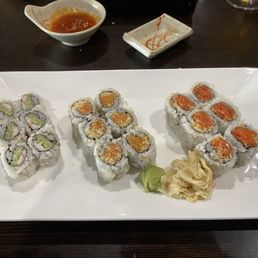 Spicy tuna and salmon rolls and a shrimp roll. Spicy tuna and salmon rolls and a shrimp roll.