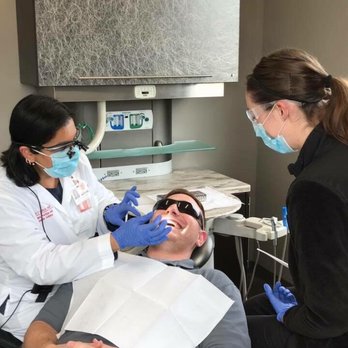 Serene Smiles - Dr Savla performing a checkup for a patienf - Cosmetic Dentists Near Me - Westerville, Ohio Serene Smiles - Dr Savla performing a checkup for a patienf - Cosmetic Dentists Near Me - Westerville, Ohio