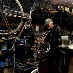 Owner, Kit, working on a bicycle in the shop