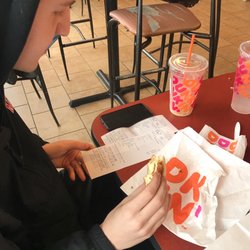 Dunkin' - distressed customer looking at receipt