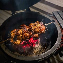 Chicken on a Rotisserie smoked in a Kamado Joe