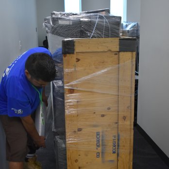 Mesa Moving and Storage - Mesa Commercial Team Member wraps full computer cart for safe transport - Movers Near Me - Boise, Idaho