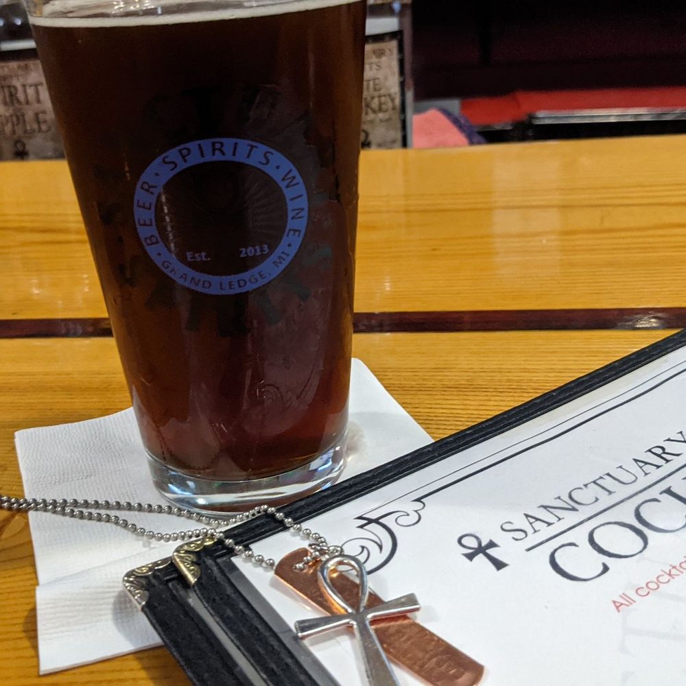 Sanctuary Spirits - a pint and menu on a table - Distilleries Near Me - Grand Ledge, Michigan Sanctuary Spirits - a pint and menu on a table - Distilleries Near Me - Grand Ledge, Michigan